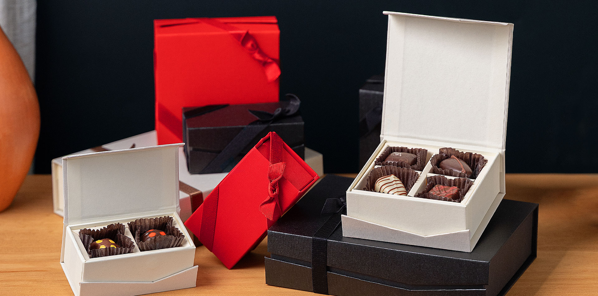 Torn Ranch chocolates and truffles in sustainable packaging, representing the shift from branded swag to gourmet corporate gifts.